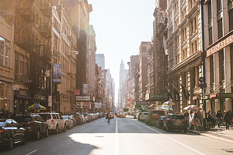 Sunny New York City Street Scene with Yellow Taxis and Pedestrians