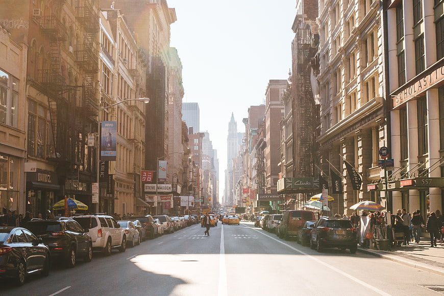 Sunny New York City Street Scene with Yellow Taxis and Pedestrians