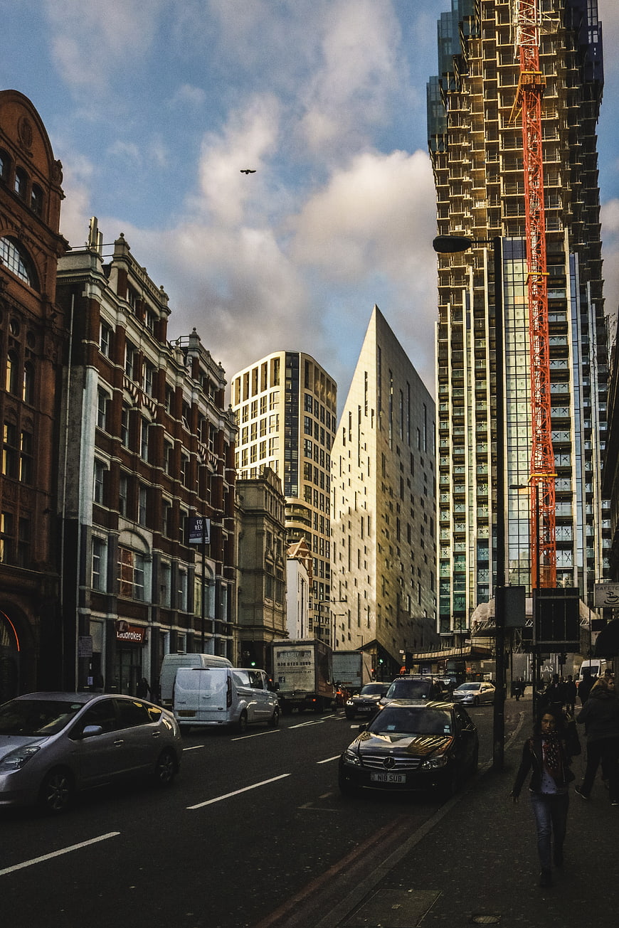 Urban street scene with modern skyscraper and construction crane
