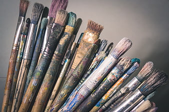 Collection of used paintbrushes with dried paint