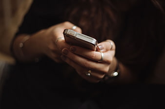 Close-up of Woman's Hands Typing on Smartphone