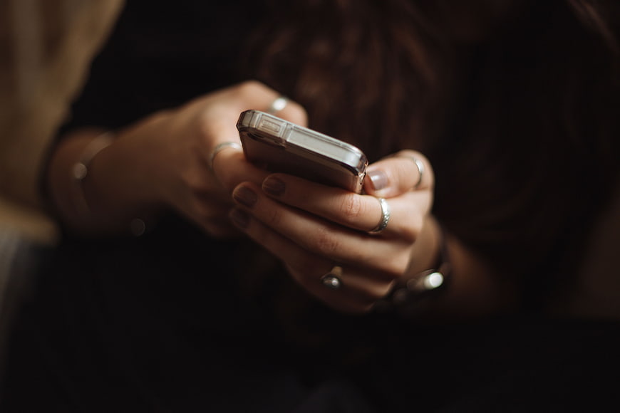 Close-up of Woman's Hands Typing on Smartphone