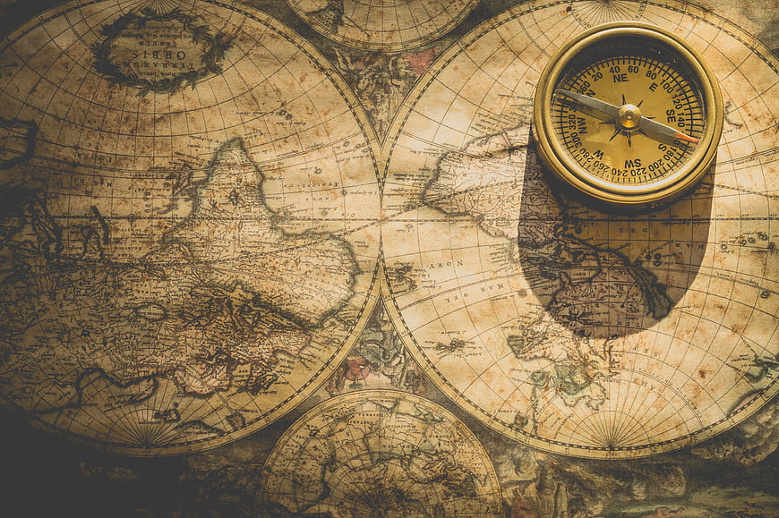 Vintage Compass on Antique World Map Background