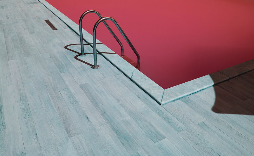 Modern Swimming Pool with Red Water and Blue Deck