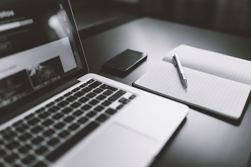 Minimalist Workspace with Laptop, Smartphone, and Notebook
