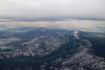 Aerial view of snow-capped mountains and winding river