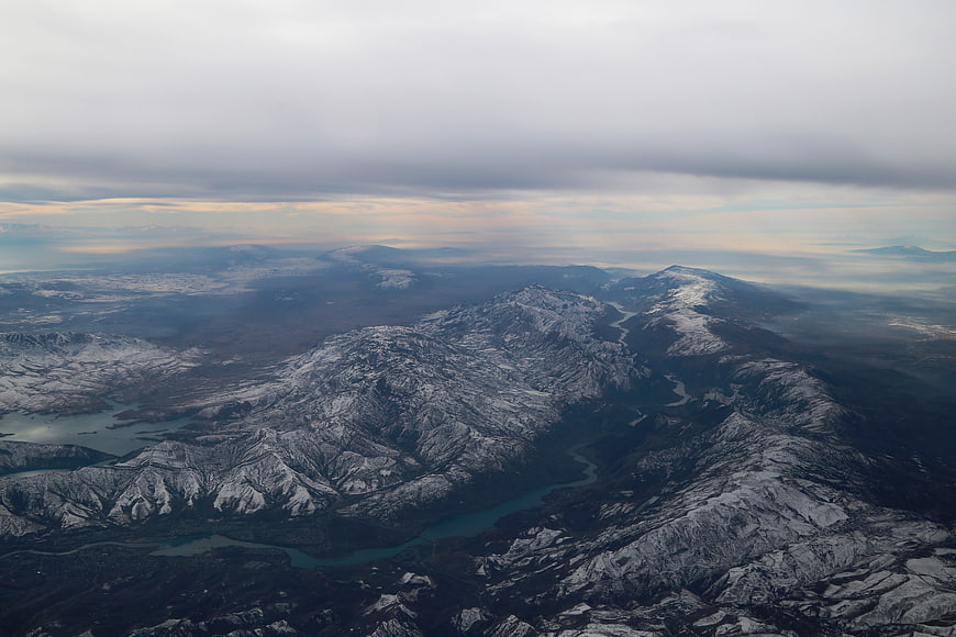 Aerial view of snow-capped mountains and winding river