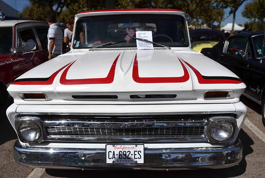 Front view of classic white Chevrolet C10 truck with red stripes