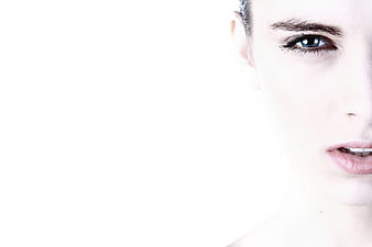 High-key studio portrait of a woman's face with blue eyes