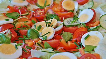 Close-Up Of Fresh Vegetable Salad With Boiled Eggs And Tomatoes