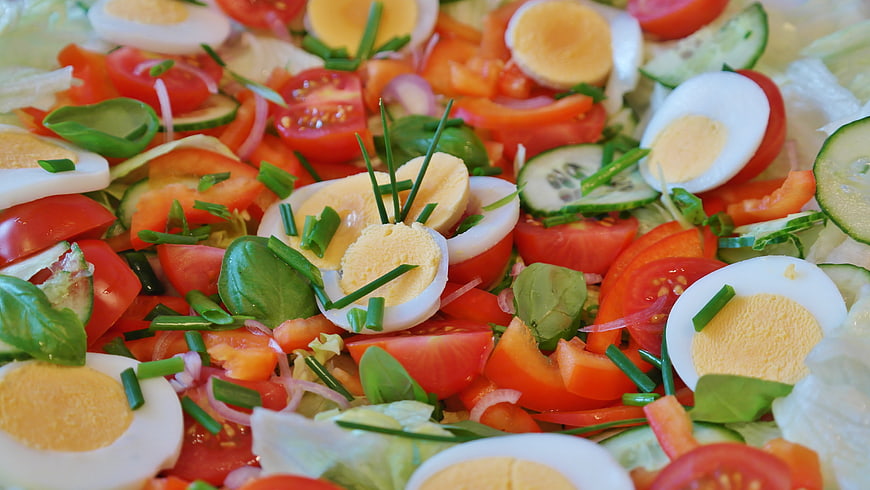 Close-Up Of Fresh Vegetable Salad With Boiled Eggs And Tomatoes