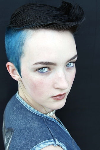 Portrait of woman with blue undercut and denim shirt
