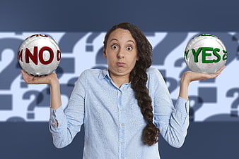 Woman holding yes and no balls expressing indecision