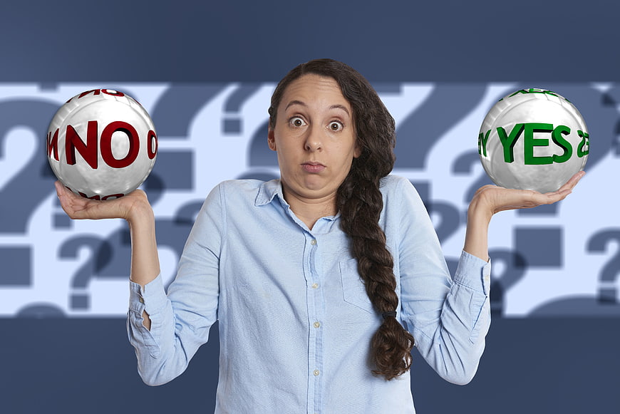 Woman holding yes and no balls expressing indecision
