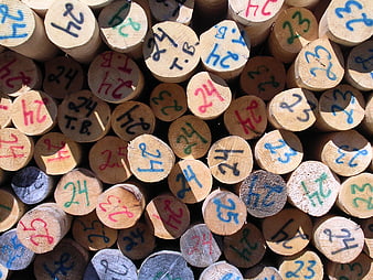 Stacked Timber Logs with Painted Numbers