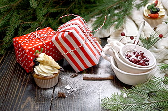 Christmas Gift Boxes With Cupcakes And Berries On Rustic Wooden Table