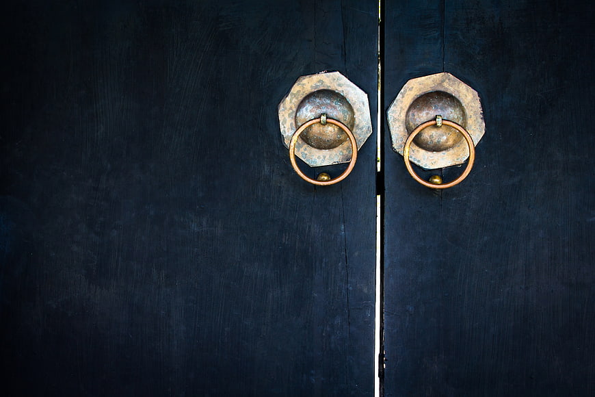 Vintage Brass Door Knobs on Dark Blue Wooden Door