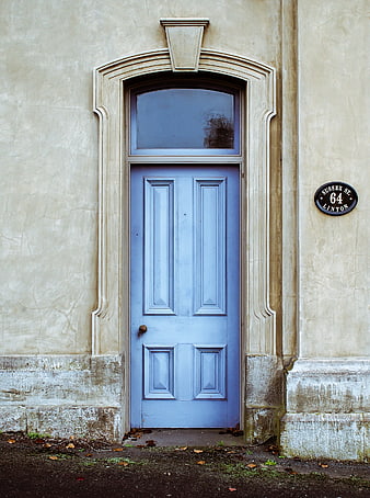 Blue Door on Beige Wall with Street Sign