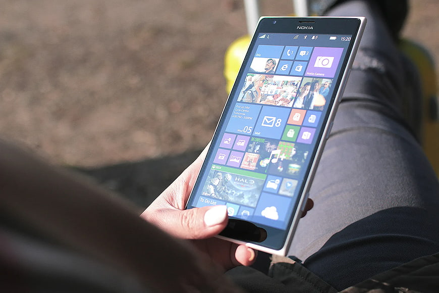 Person holding Nokia smartphone with Windows interface