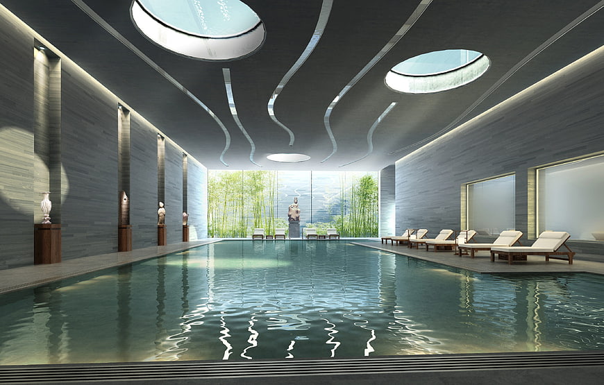 Luxurious indoor swimming pool with skylights and bamboo garden view