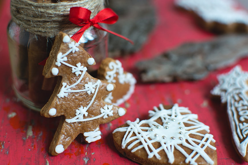 Christmas gingerbread cookies on red wooden table