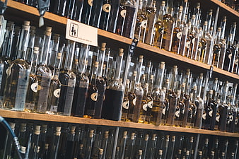 Shelves of homemade liqueur bottles in a store
