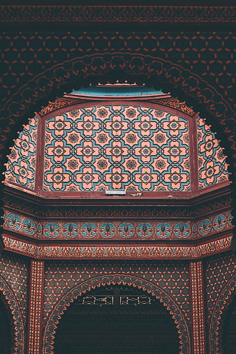 Intricate Islamic geometric ceiling patterns in teal and terracotta