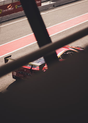 Red Ferrari Race Car on Circuit Track