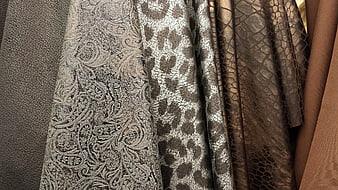 Close-up of textured brown and beige fabric swatches with vintage patterns