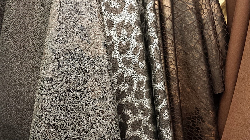Close-up of textured brown and beige fabric swatches with vintage patterns