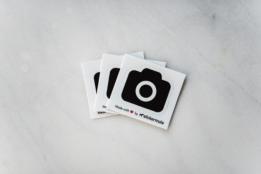 Camera Icon Stickers on White Marble Surface