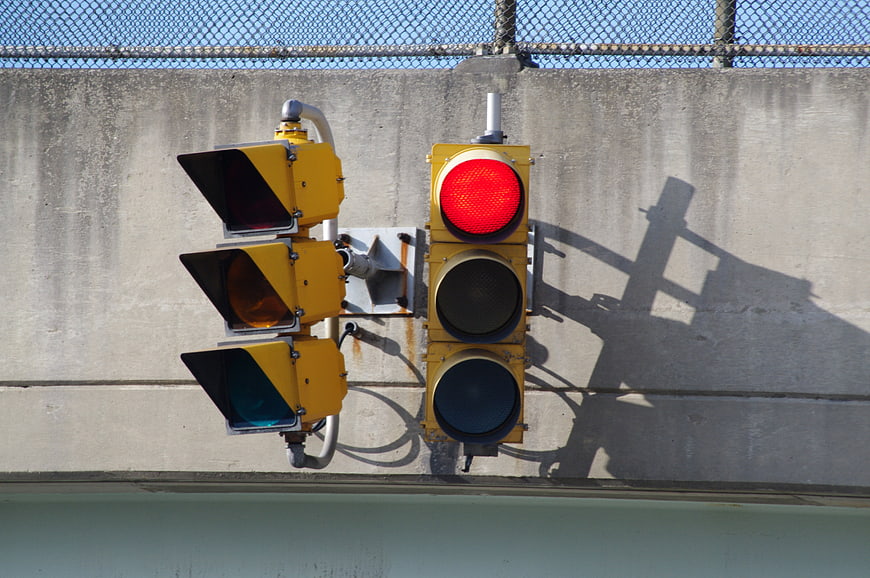 Red Traffic Light Signal on Concrete Wall