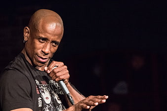 Bald African American Male Comedian Performing Stand Up With Microphone
