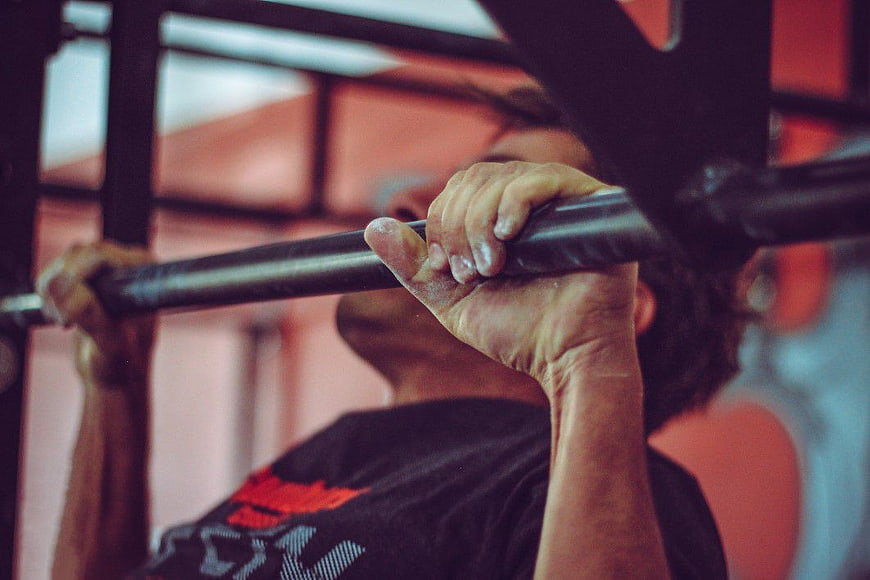 Close-up of Man Doing Pull-ups in Gym