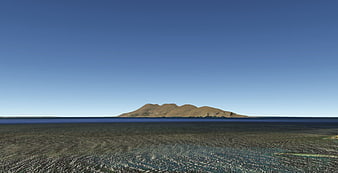 Panoramic view of a desert island in a vast blue ocean