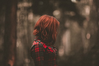 Woman with Red Hair in Plaid Shirt in Forest