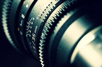 Close-up of vintage camera lens with 35mm focal length markings