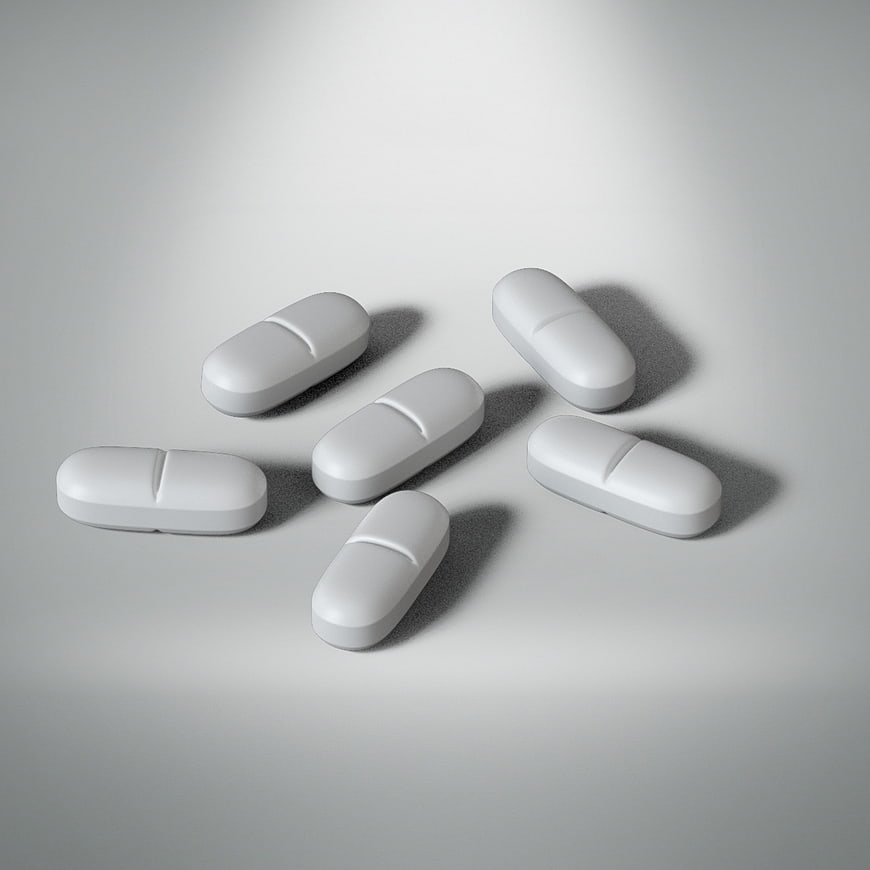White Capsule Pills Scattered On Gray Background