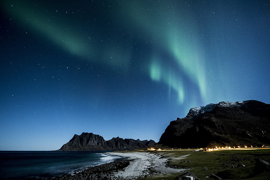 Aurora Borealis over Norwegian Coastal Mountains at Night