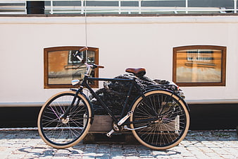 Vintage black bicycle parked on cobblestone street