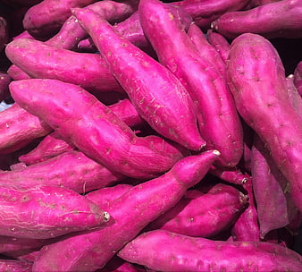Vibrant Purple Sweet Potatoes Piled in Market Display