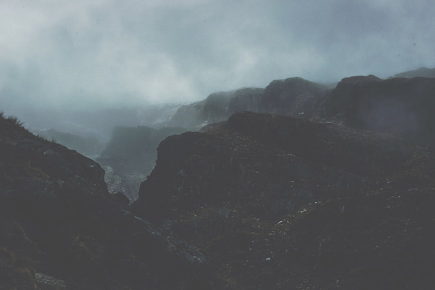 Dark Moody Mountain Landscape Shrouded in Thick Fog