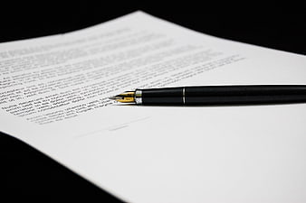 Black fountain pen on contract document ready for signature