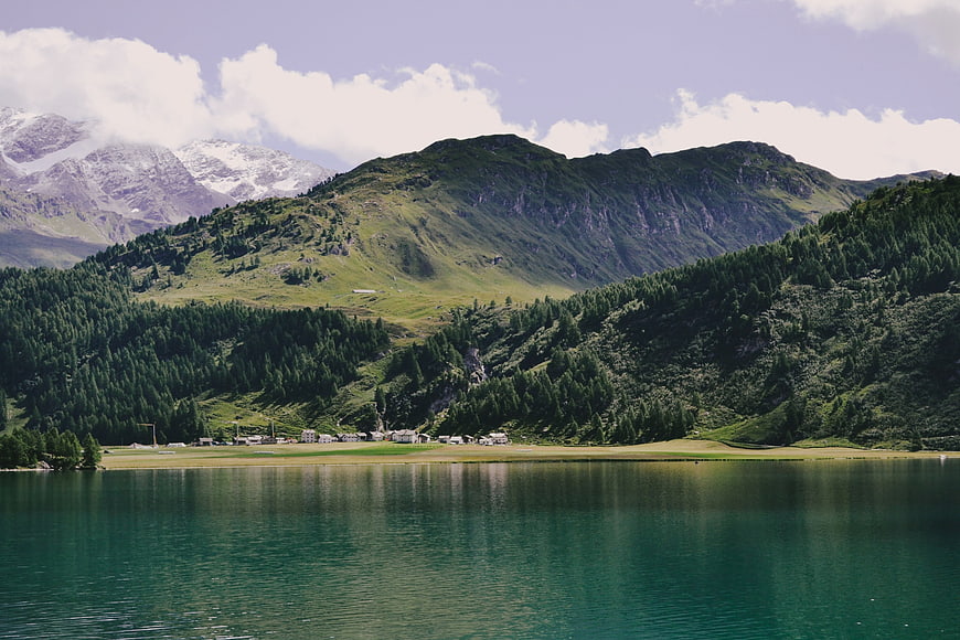 Serene Alpine Lake with Snow-Capped Mountains and Green Forests