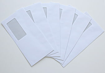Stack of white window envelopes on white background