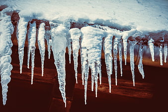Icicles Hanging From Snowy Wooden Roof Eaves