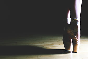 Ballerina en Pointe on Wooden Stage Floor
