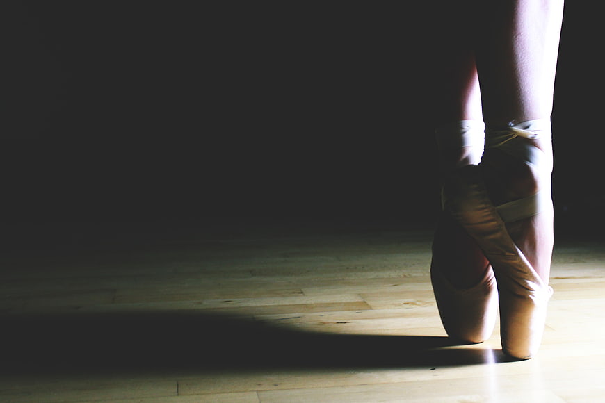 Ballerina en Pointe on Wooden Stage Floor