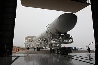 Large white rocket transported on transporter erector vehicle