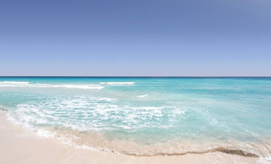 Turquoise Caribbean Beach with White Sand and Clear Blue Sky